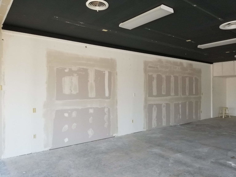 Tenant space after — rear wall view showing finished drywall