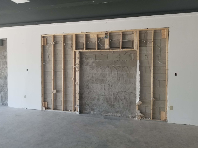 Tenant space before — open shell with damaged walls