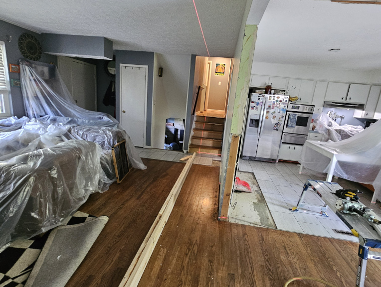Kitchen side before — wall fully intact