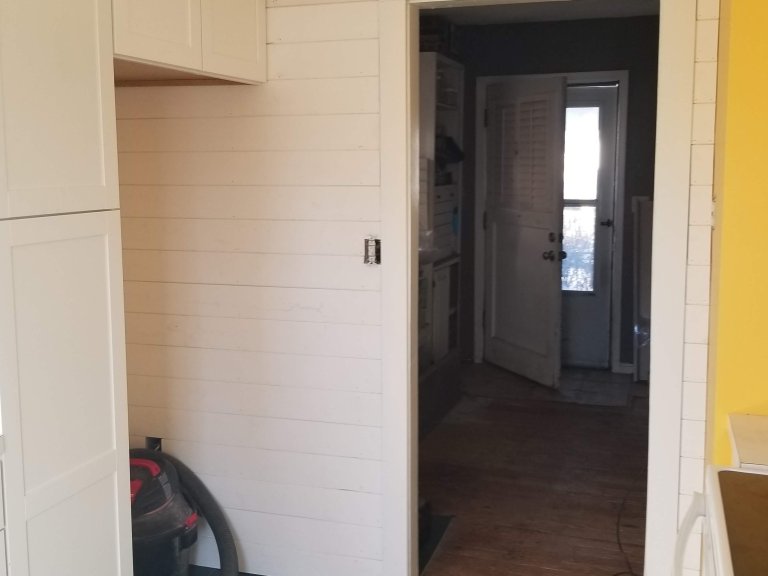 Cabinets installed with a custom wrap around the refrigerator