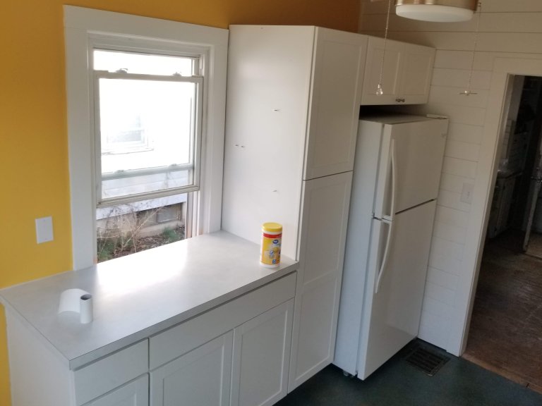 Prep area showing how the cabinet install wraps the refrigerator