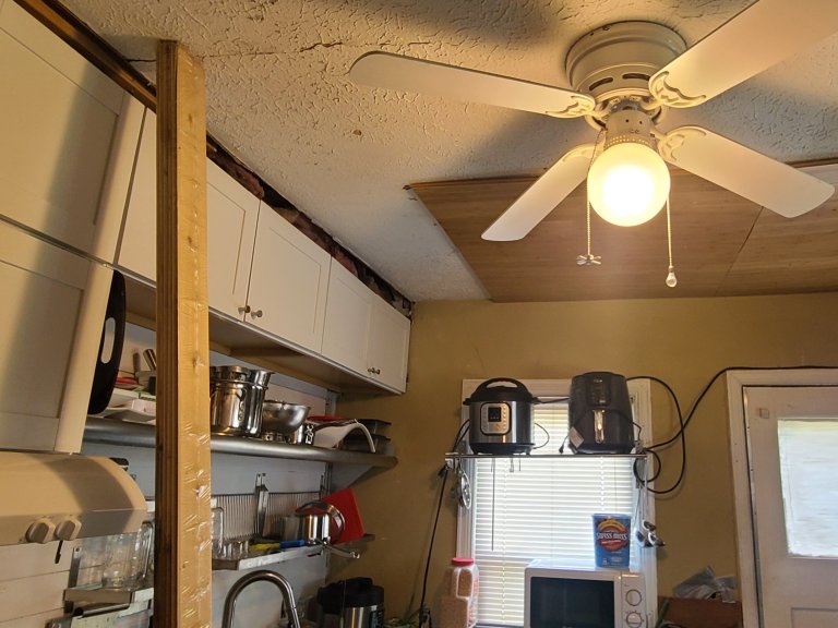 2x4 propped under the ceiling with plywood patchwork above the door header