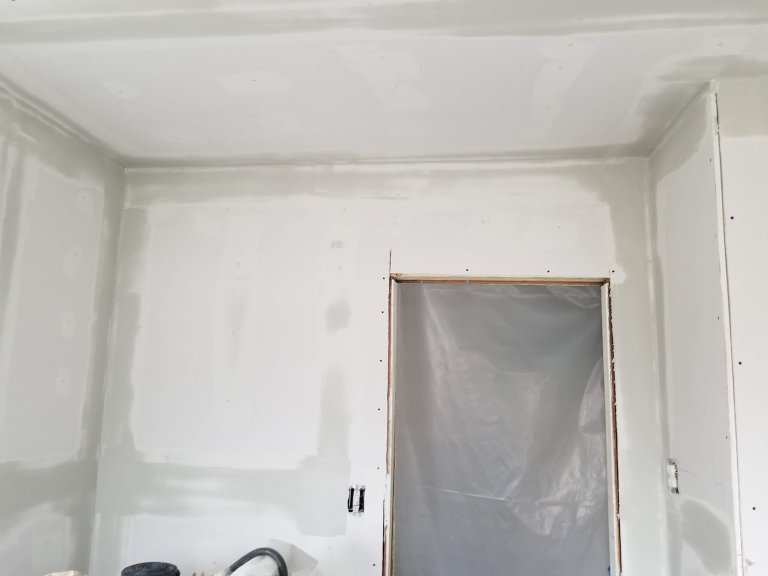 New drywall with a fresh tape coat of joint compound