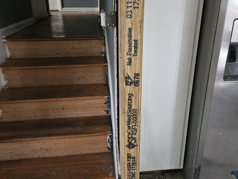 Engineered LVL column recessed at the bearing point — ready to be wrapped and hidden inside the finished wall