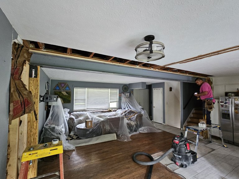 Structural scope complete — 22-foot I-beam spanning the full opening from kitchen to living room