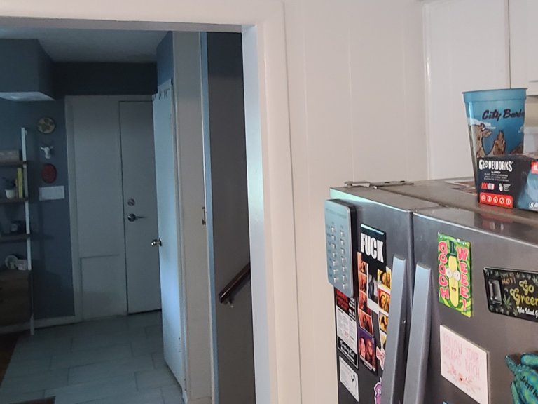 View from the kitchen looking toward the living room — the bearing wall limited the connection between spaces to a single doorway