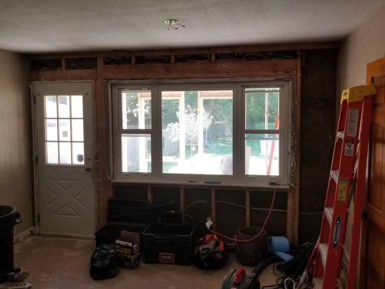 Load-bearing wall opened to studs during demo