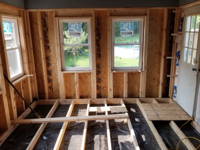 Vapor barrier installed over the concrete porch slab