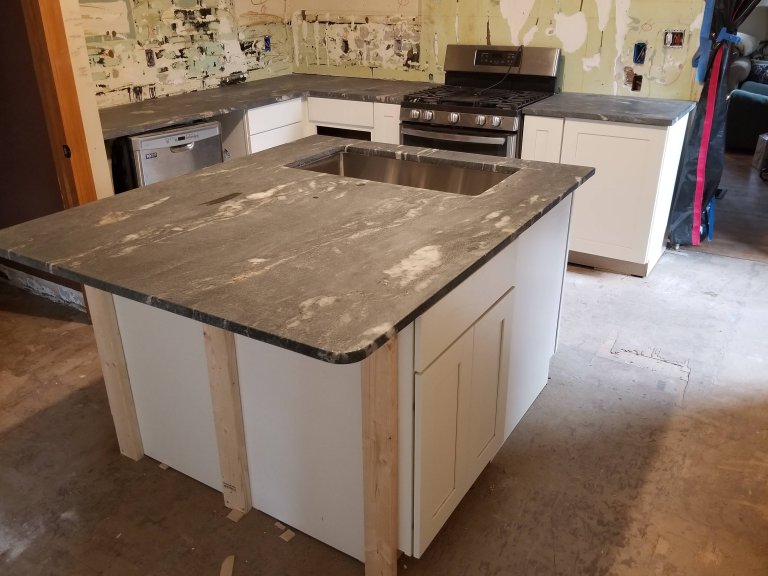 Cabinetry and countertops installed — walls and flooring still in progress