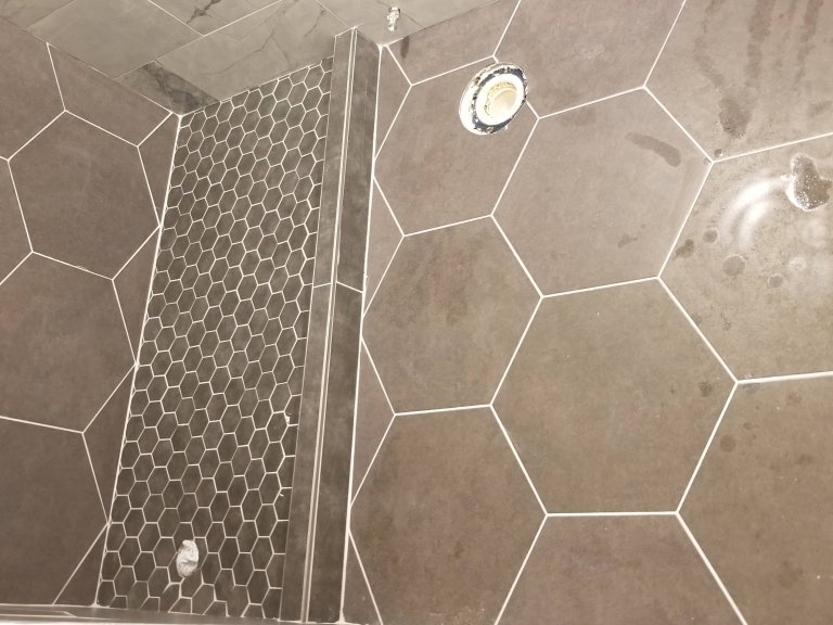 Bath from left to right. shower stall and bath floor tile fresly grouted