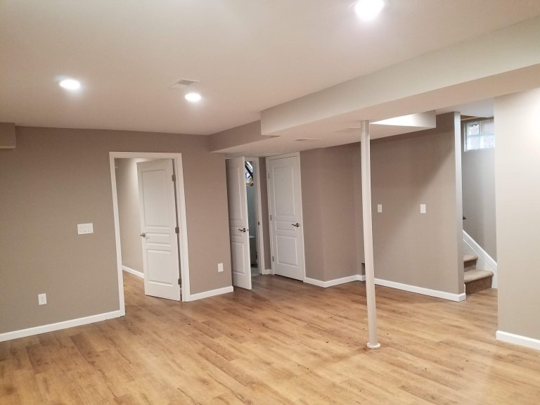 basement facing east. Bedroom on left and utility room center and under step storage