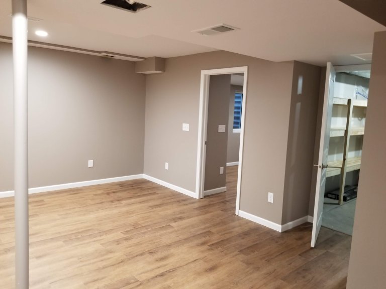 Basement standing at steps facing northeast focused on egress window in bedroom