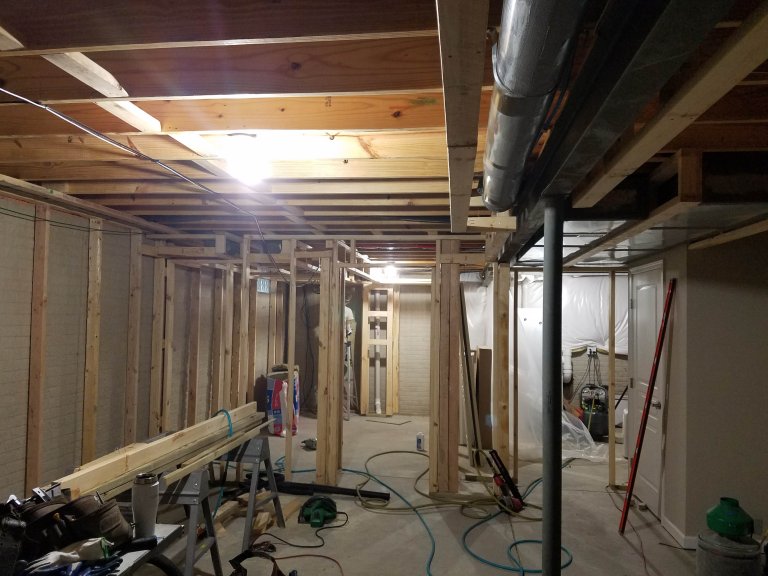 Basement living area facing new bedroom